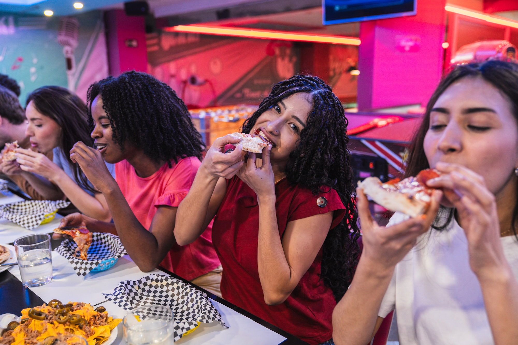 Friends eating Austin pizza and nachos